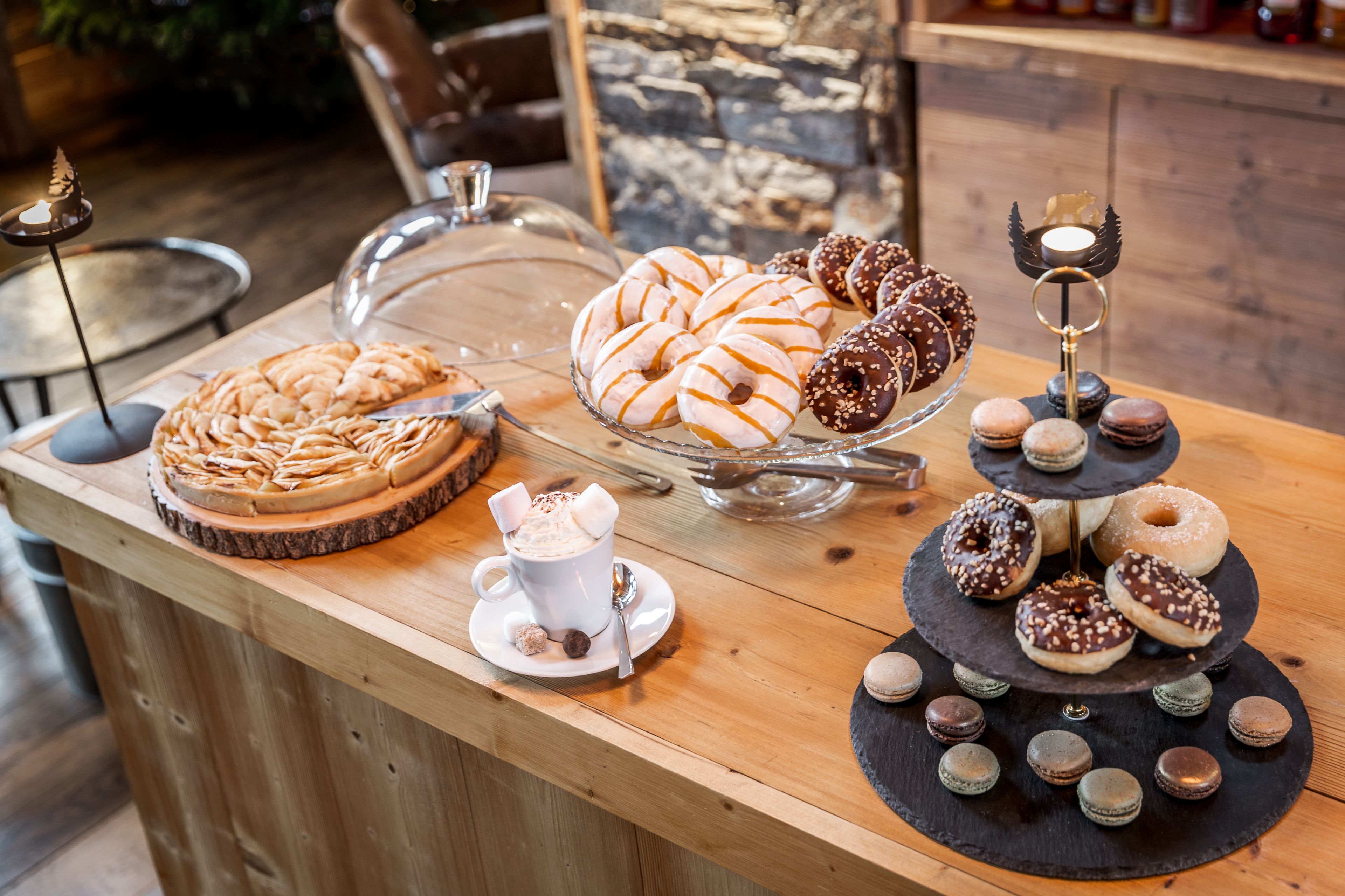 A dessert display with various pastries and a coffee cup.