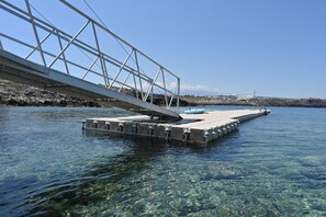 A clear view of a bridge over water with a dock extending into the water. - Kavos Hotel (Chania)