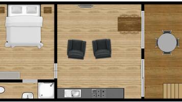 Un plan d’une chambre d’hôtel comprenant un lit, deux fauteuils, une table et une salle de bain.