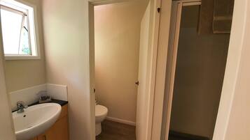 A bathroom with a sink, toilet, and shower.