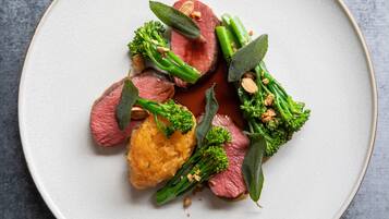A plate of food with various vegetables and a piece of meat.