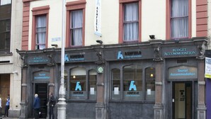 A multi-story building with a cream and red facade, featuring several ground-floor storefronts labeled "Ashfield A Star Backpackers" and "Budget Accommodation." - Ashfield Hostel (Dublin)