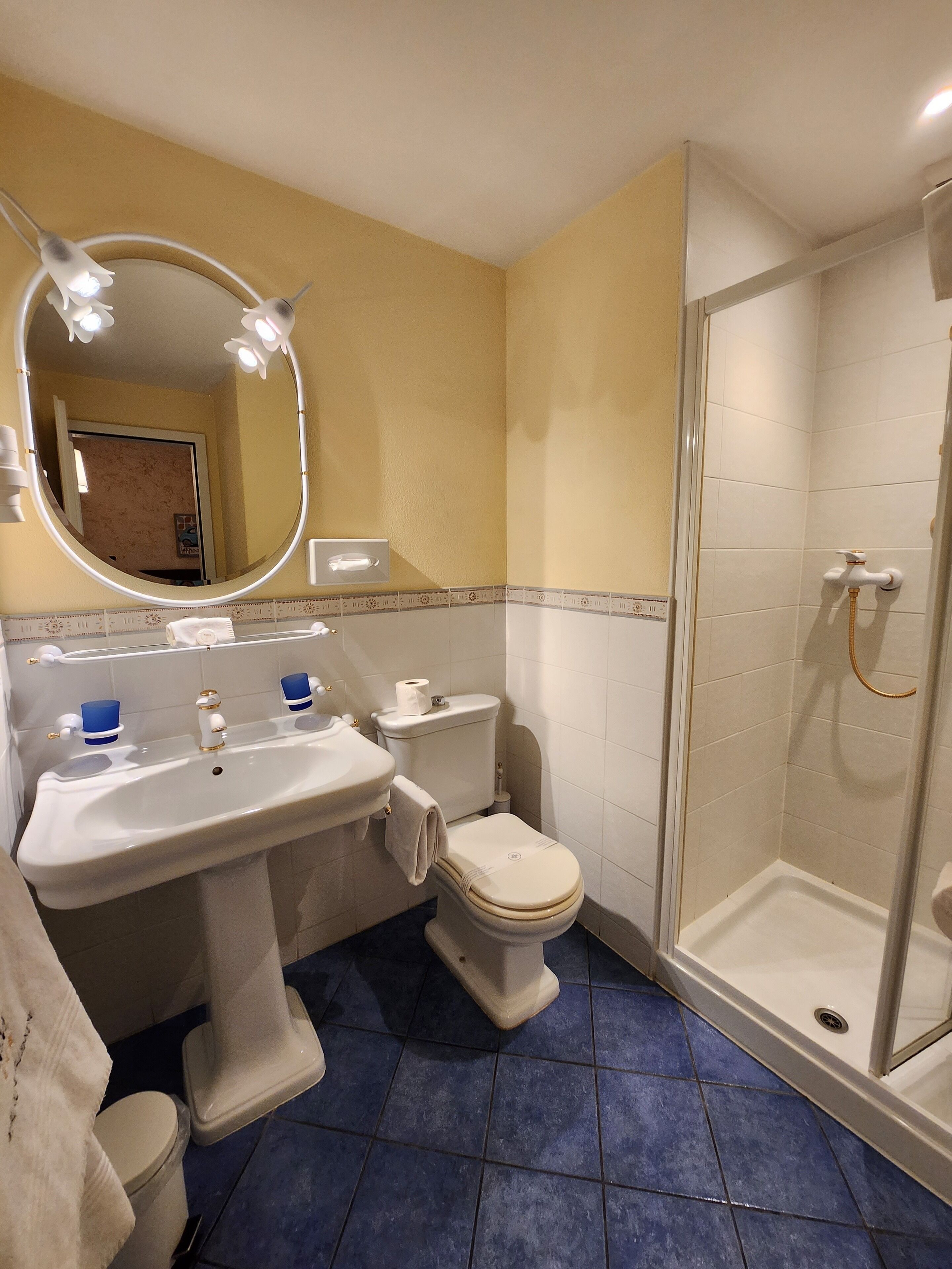 A bathroom with a sink, toilet, and shower.
