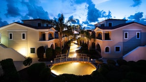 A residential area with symmetrical houses, a central pathway, and a small bridge. - Messina Resort Hotel (Trifylia)