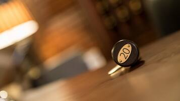 A close-up of a round, black object with a gold number "20" on it, placed on a wooden surface.