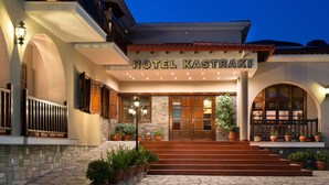 A hotel entrance with a sign reading "HOTEL KASTRAKI," steps leading up to the door, and potted plants around the entrance. - Hotel Kastraki (Kalabaka)