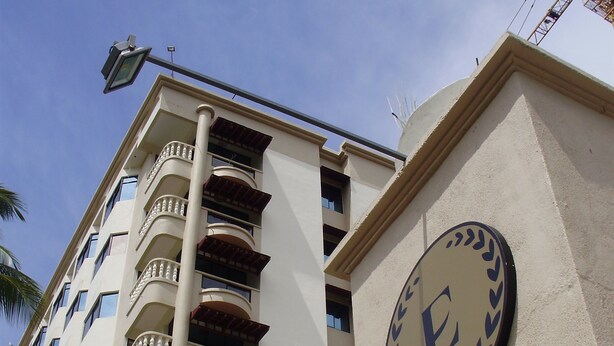 A hotel building with multiple balconies and a sign indicating it is a hotel. - Eagle Bay Hotel (Langkawi)