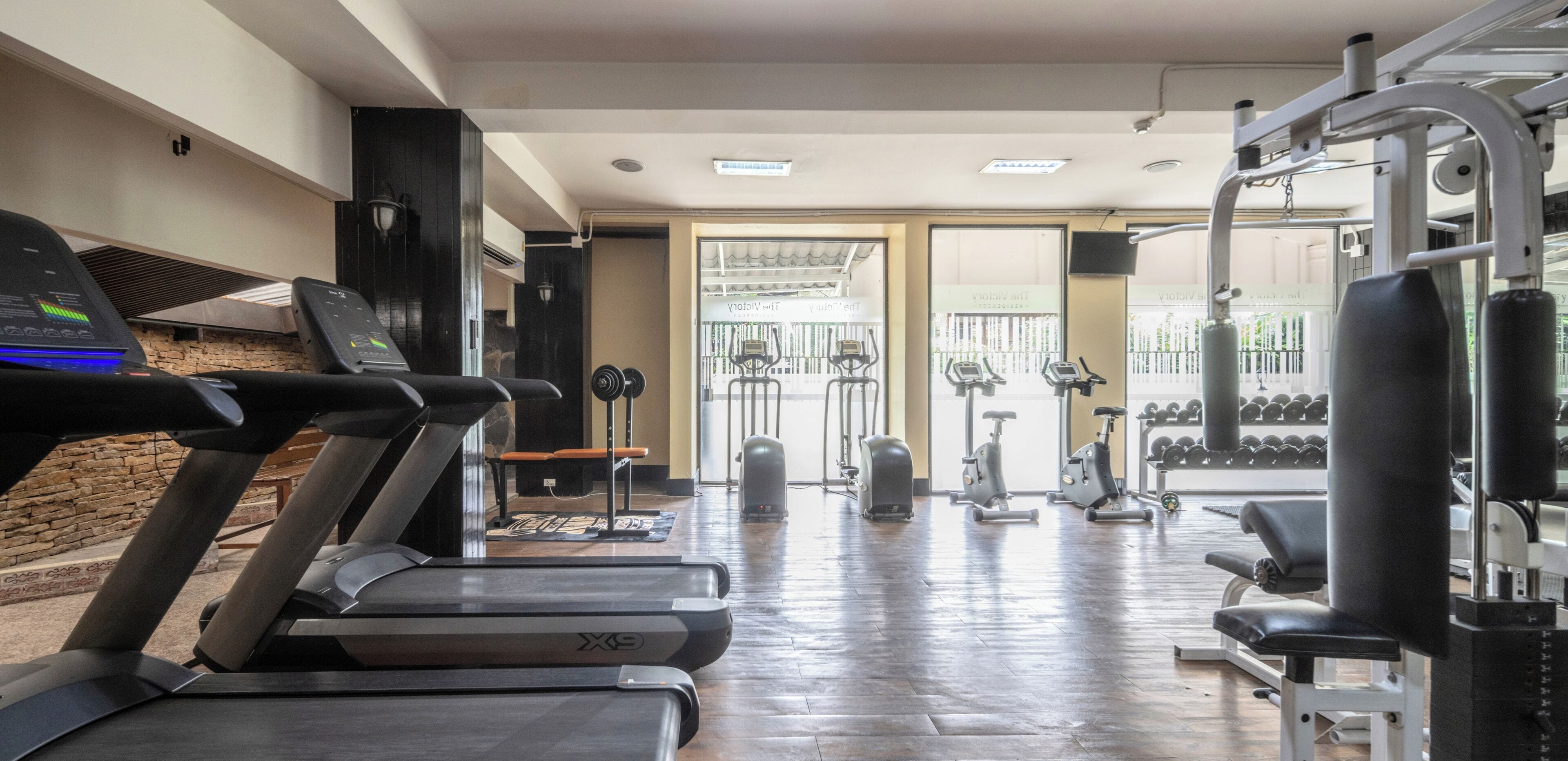 A gym with treadmills, stationary bikes, and weight machines.