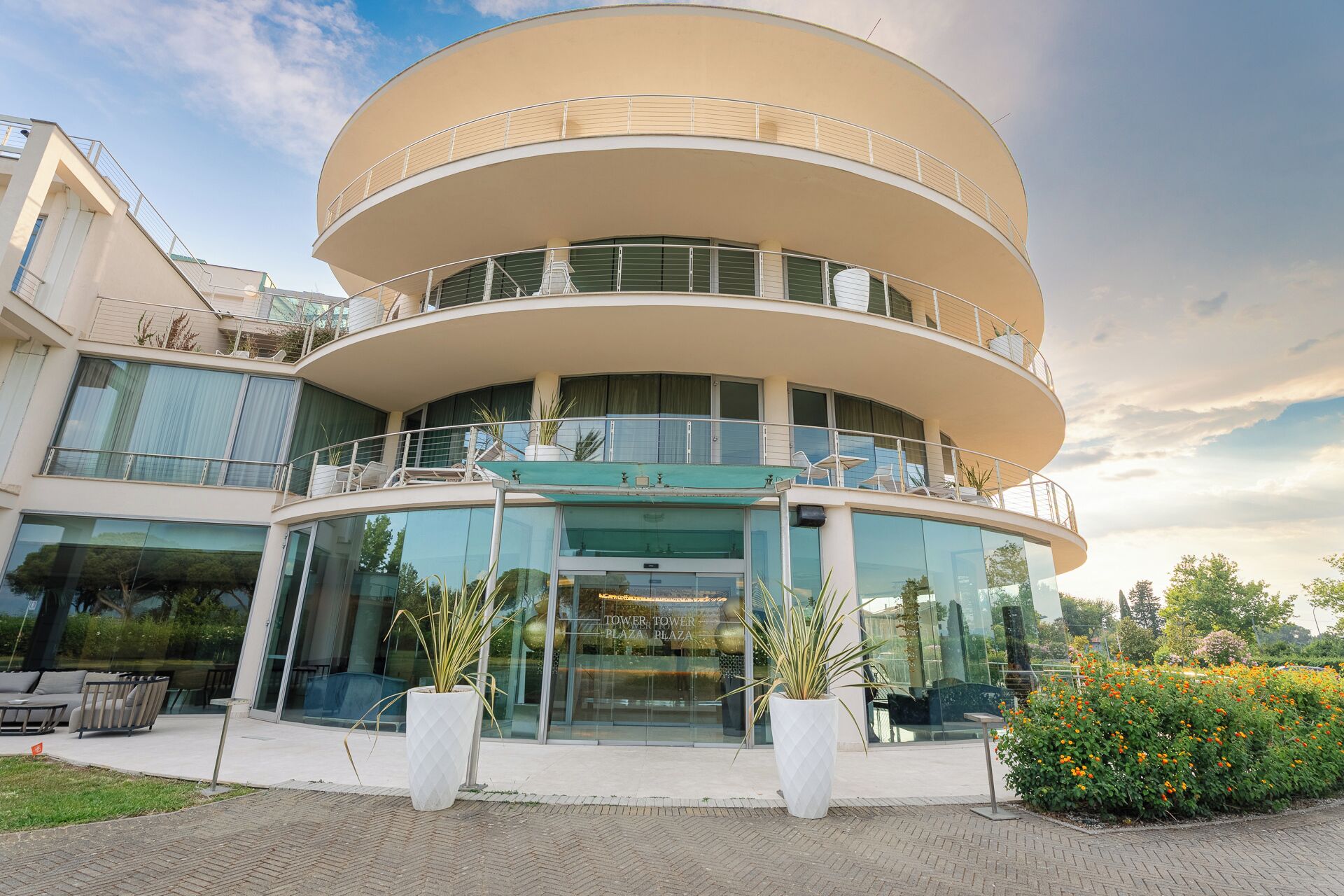 A multi-story building with a curved facade, balconies, and large windows.