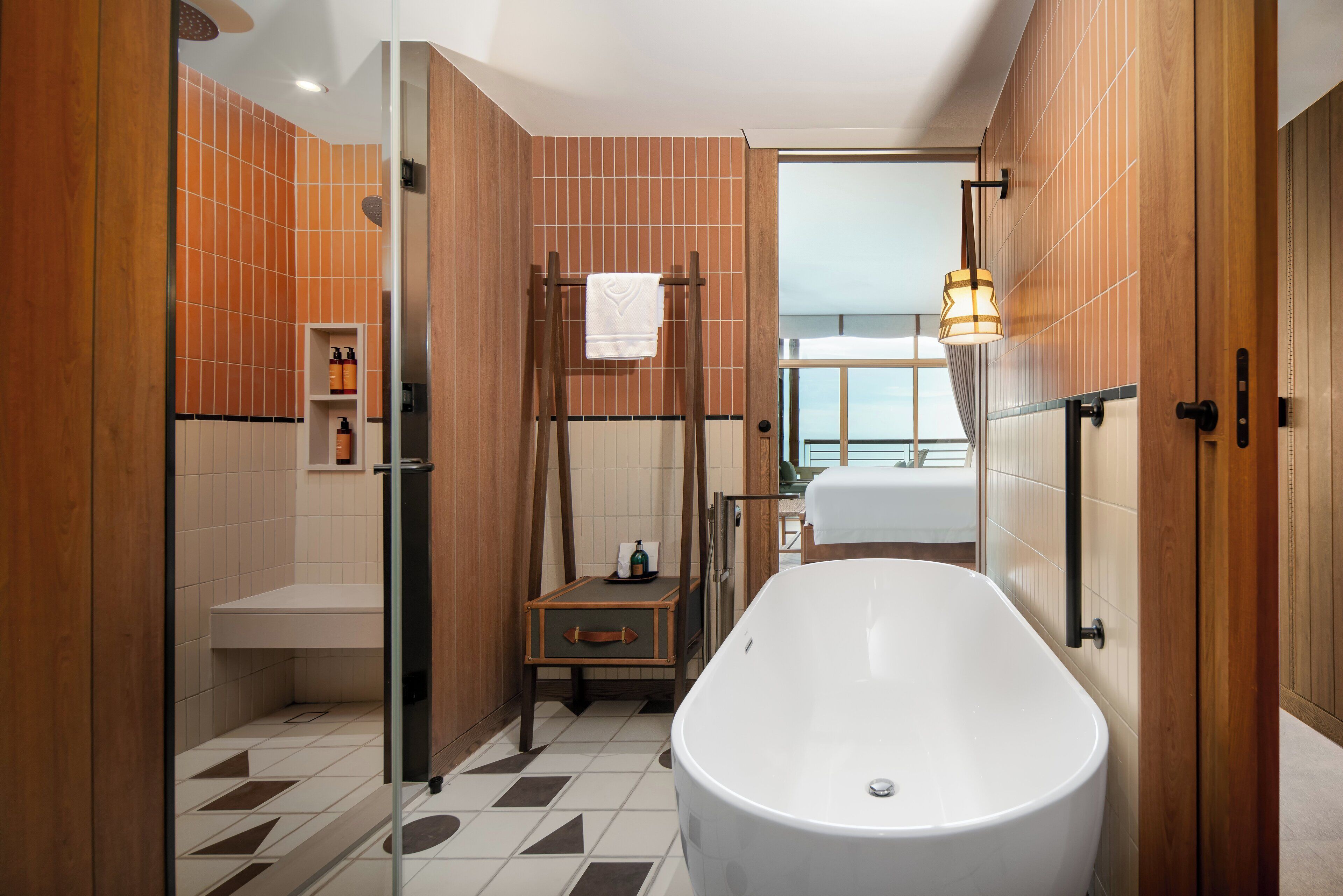 Un baño moderno con una bañera independiente, cabina de ducha de vidrio y paneles de madera.