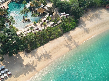 On the beach, white sand, beach umbrellas, beach towels. Centara Grand Mirage Beach Resort Pattaya