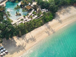 On the beach, white sand, beach umbrellas, beach towels