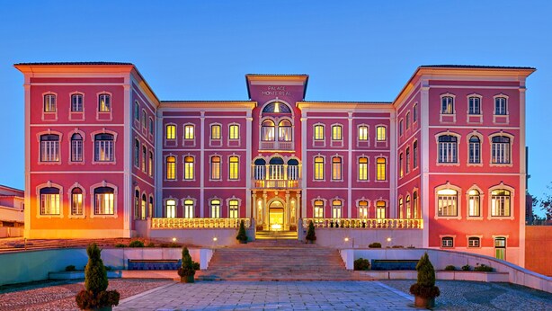 A large, multi-story building with a grand entrance, multiple windows, and a symmetrical facade. - Monte Real Hotel, Termas & Spa (Leiria)