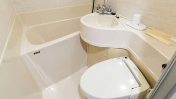 A bathroom with a bathtub, a sink, and a toilet.