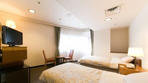 A hotel room with two beds, a television, a desk, and a chair. - Hotel Ohedo (Tokyo)