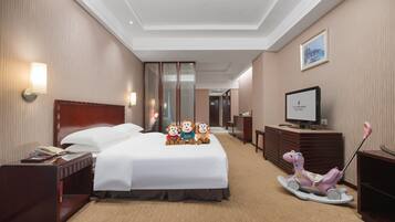 Cozy retreat with a comfortable bed, a nightstand, and a TV, perfect for unwinding.