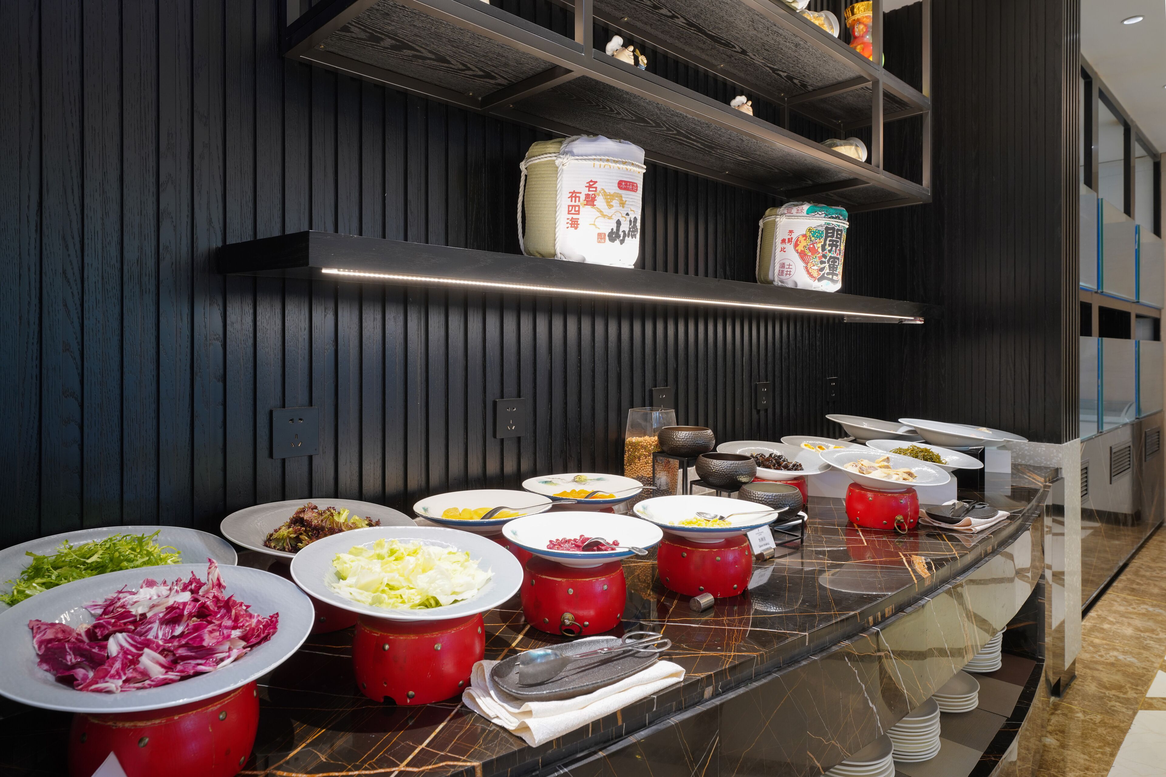 Buffet amb diferents aliments i recipients damunt un taulell de marbre.