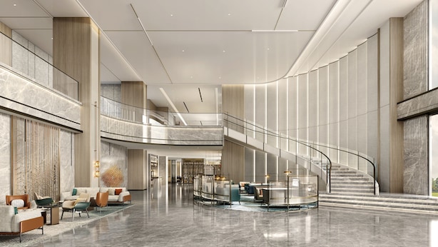 A spacious lobby with a curved staircase, seating areas, and a high ceiling. - Crowne Plaza Shanghai Jinxiu by IHG (Shanghai)