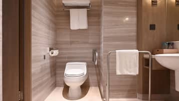 A modern bathroom with a toilet, towel rack, and sink.