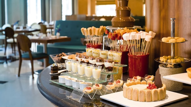 A buffet with various desserts and a hot chocolate fountain. - Avani Deira Dubai Hotel (Dubai)