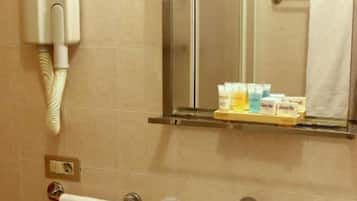 A bathroom with a sink, mirror, towel rack, and toiletries.