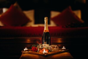 Enjoy a romantic evening with a bottle of wine, a glass, and a rose.