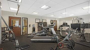 A gym with treadmills, elliptical machines, and weight equipment.