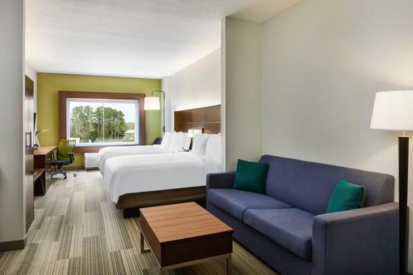 A hotel room with a bed, a sofa, a desk, and a chair. - Holiday Inn Express Palatka Northwest by IHG (Palatka)