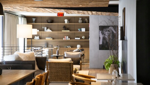A modern interior with a sofa, chairs, a dining table, and a bookshelf. - The Lloyd Stamford, Tapestry Collection by Hilton (Stamford)