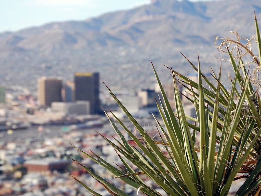 A desert landscape with a city in the background.