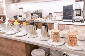 A breakfast buffet setup with various food items and coffee machines. - City Lake Hotel (Taipei)