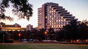 A multi-story hotel with a modern design, featuring a prominent "HOTEL" sign at the top. - Hotel Cascade (Most)