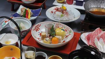 A variety of dishes and bowls on a table, suggesting a meal setting.