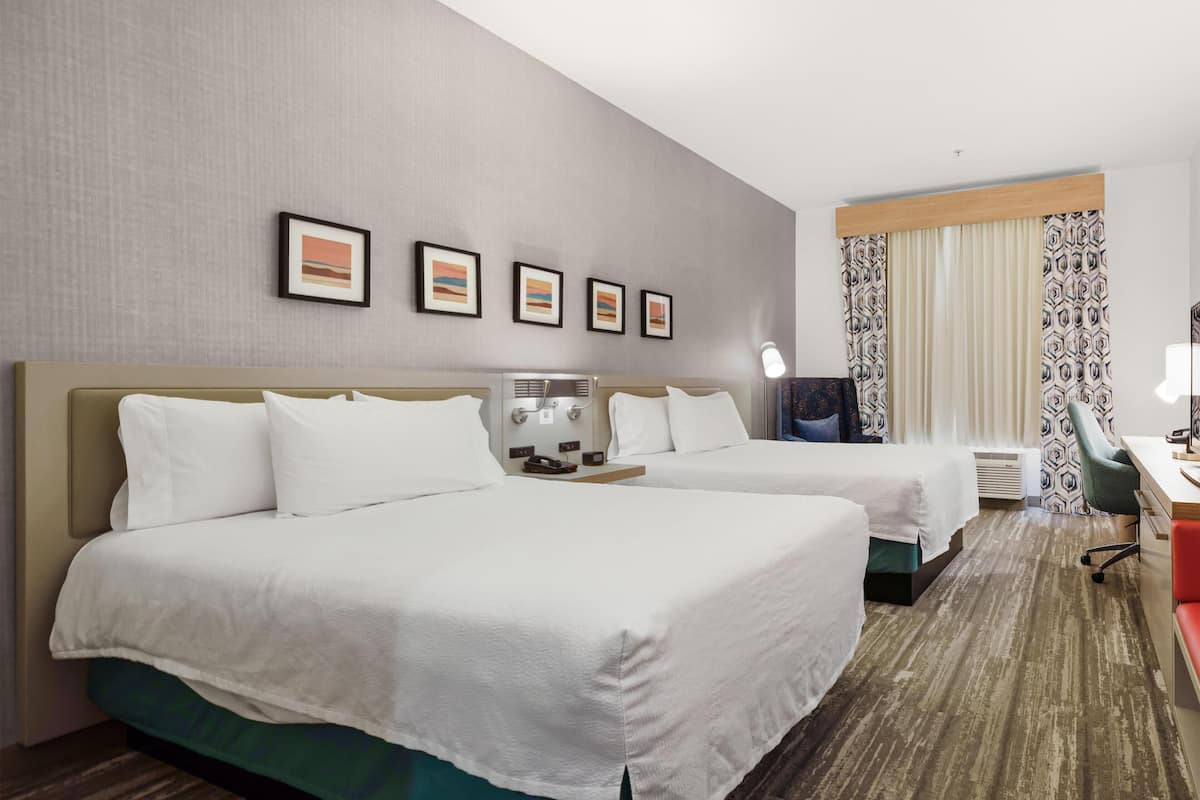 Two queens evolution room | Desk, laptop workspace, blackout drapes, iron/ironing board