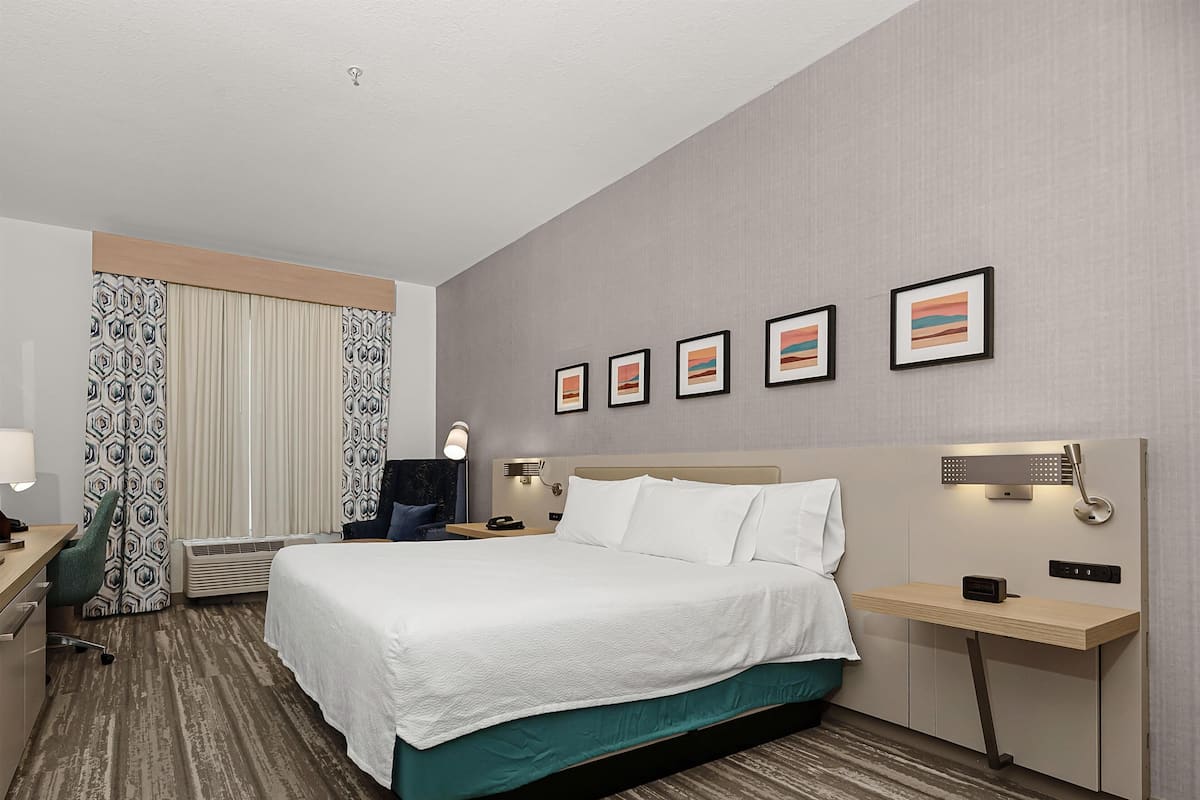 King bed evolution room | Desk, laptop workspace, blackout drapes, iron/ironing board