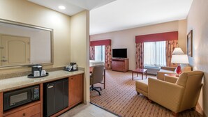 A hotel room with a kitchenette, a TV, a sofa, and a dining area. - Hampton Inn & Suites Arcata (Arcata)