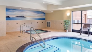 An indoor swimming pool with a view of the ocean through a mural, a hot tub, and a seating area with a potted plant. - Hampton Inn & Suites Arcata (Arcata)