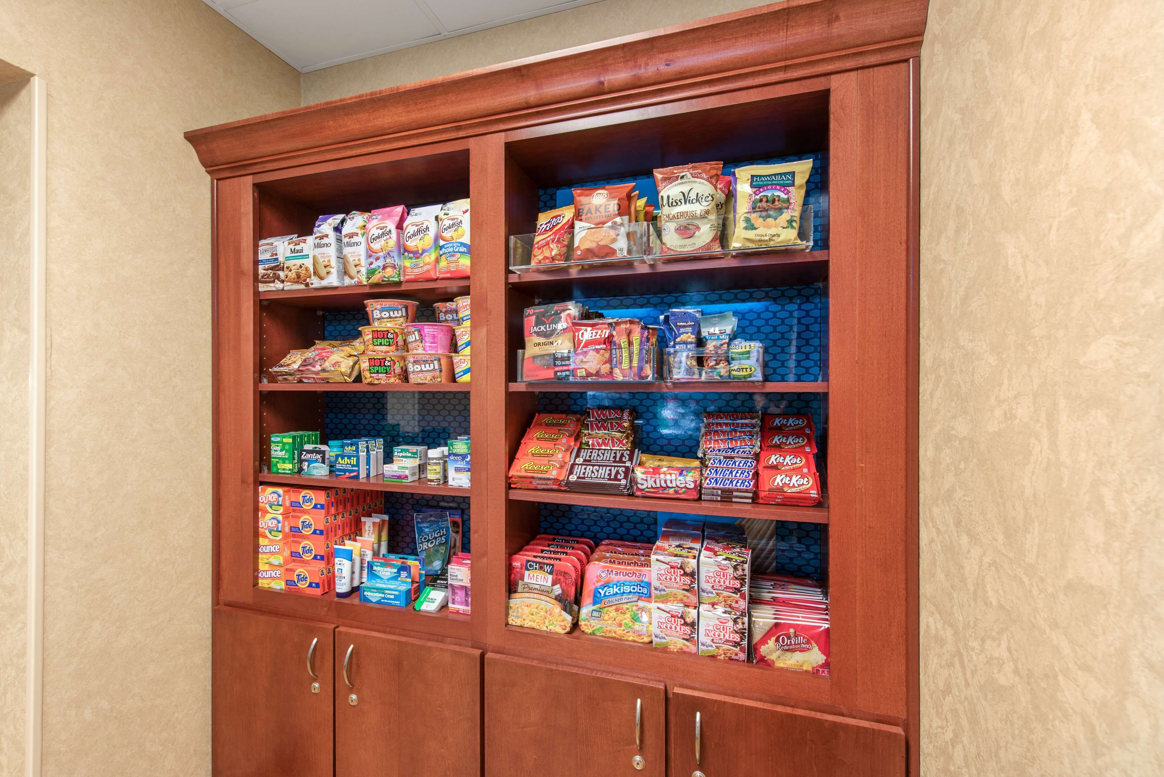 A pantry stocked with various food items including cereals, snacks, and baking supplies.