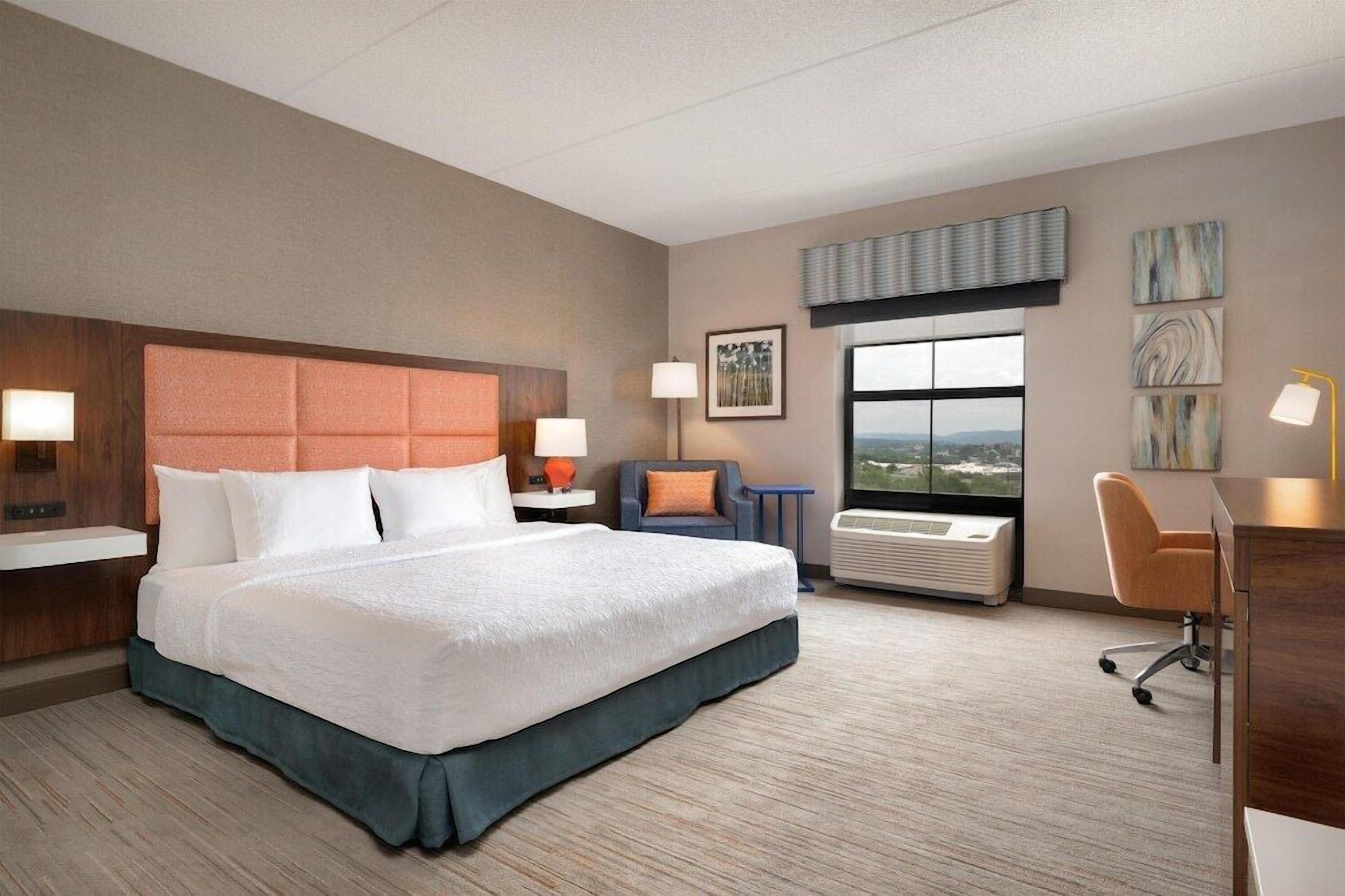 Premium bedding, desk, laptop workspace, blackout curtains