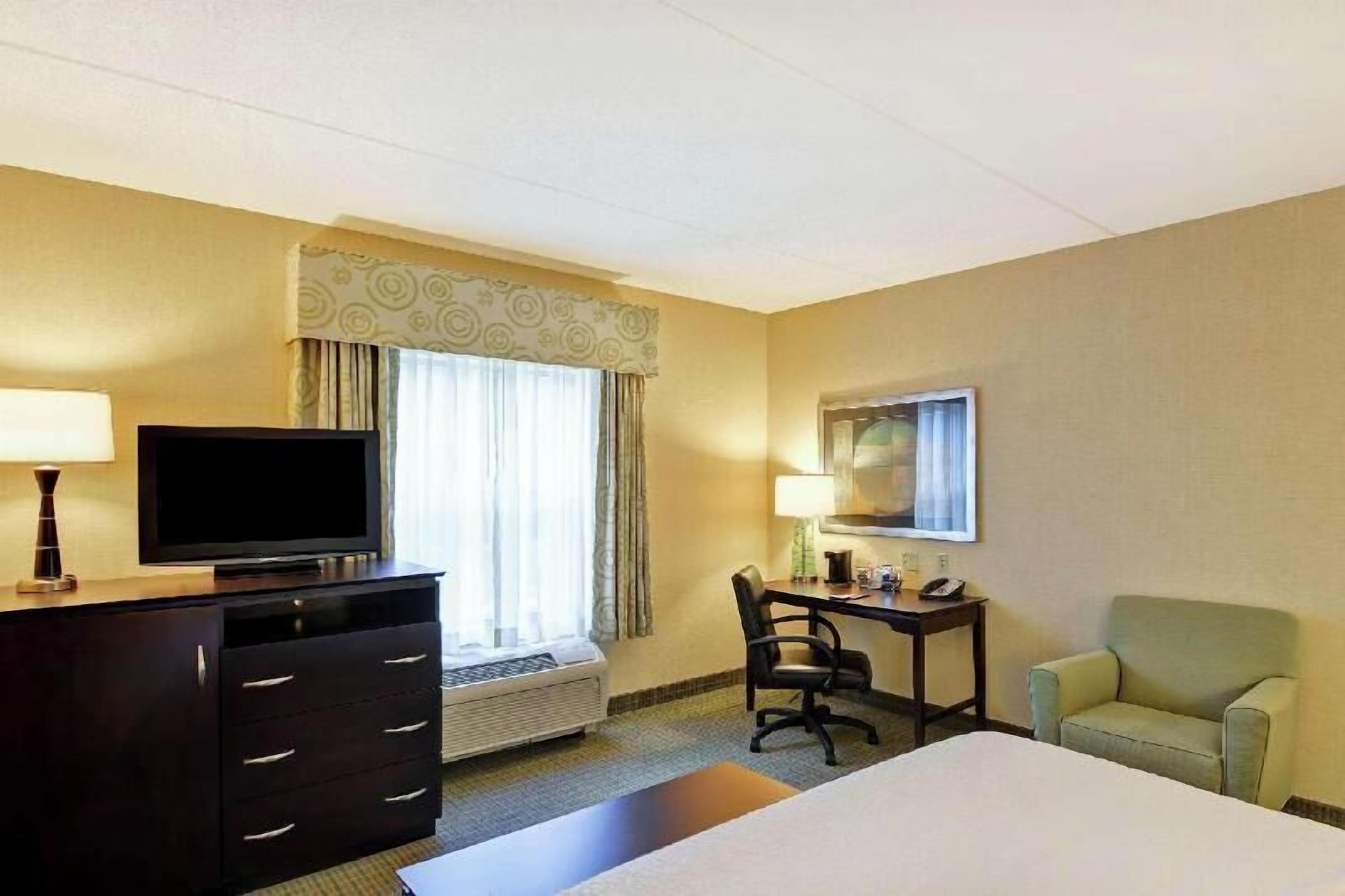 Premium bedding, desk, laptop workspace, blackout curtains