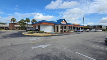 A parking lot with a building labeled "Mike's GRILL" and a sign for "Breakfast - Lunch - Dinner - Waffles".