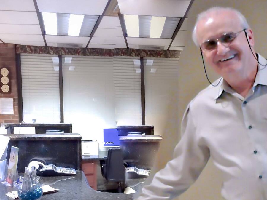 An office with desks, computers, and a reception area.