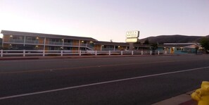 A motel with a signboard, a fenced parking area, and a yellow fire hydrant. - Villa Motel (San Luis Obispo)
