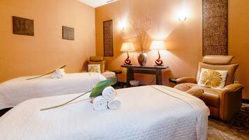Two single beds with white linens and decorative touches await in this stylish room.
