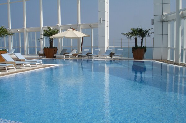 Seasonal outdoor pool, open 7 AM to 6:00 PM, pool loungers