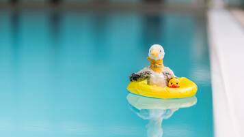 A duck float in a clear blue pool.