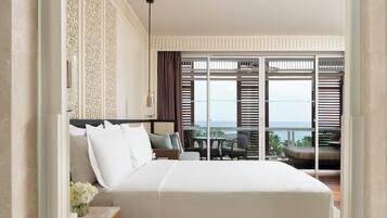 A modern hotel room with a large bed, a bathroom with a bathtub, and a balcony with a view.