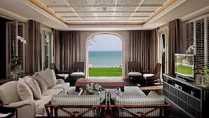 A luxurious living room with a view of the sea, featuring a sofa, armchairs, a coffee table, and a TV. - Intercontinental Hua Hin Resort by IHG (Hua Hin)