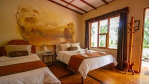 A room with two beds, a mural on the wall, and a window with curtains. - Hotel La Rosa de America (San José)