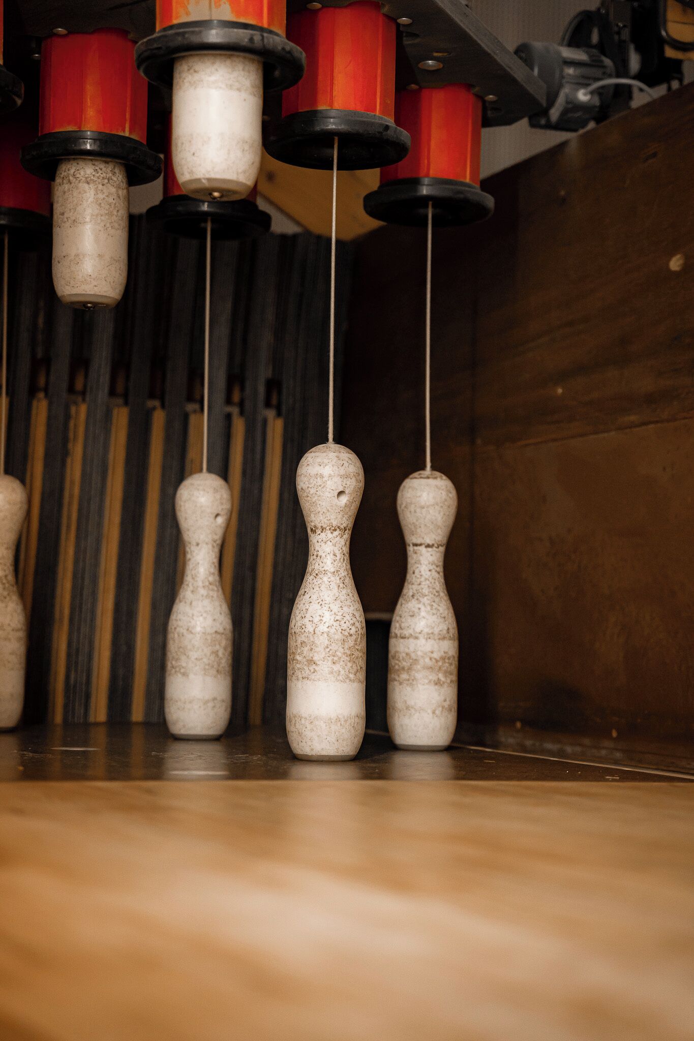 A close-up of bowling pins with a wooden background.